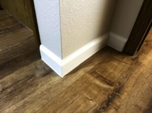Installing vinyl baseboards in a modern home renovation project